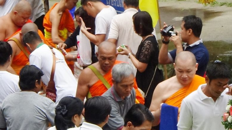 ชาวพิษณุโลกตักบาตรเทโวท่ามกลางสายฝนโปรยปราย
