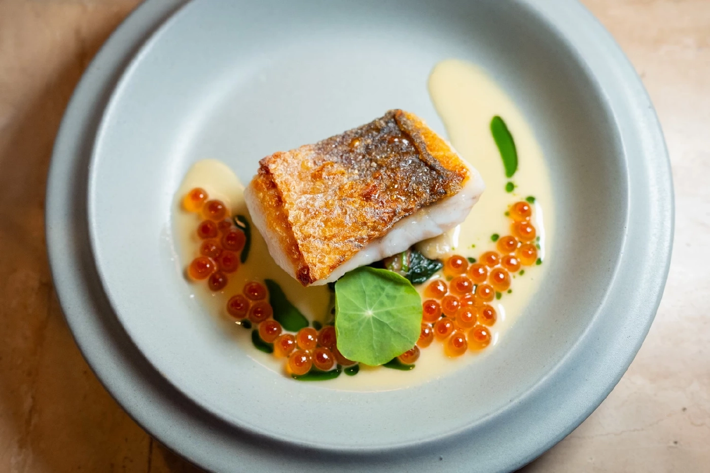 .Pan-fried sea bass with beurre blanc sauce